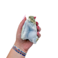 Blue lace agate raw geode held in hand to show scale