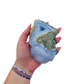 Blue lace agate raw geode held in hand to show scale