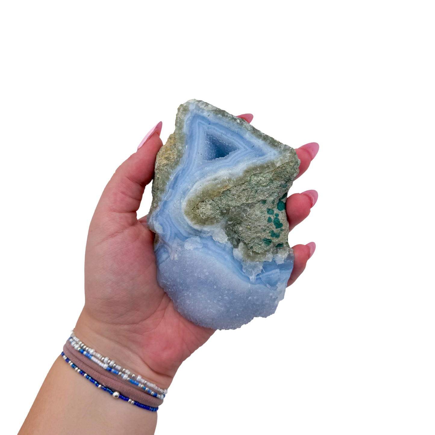 Blue lace agate raw geode held in hand to show scale