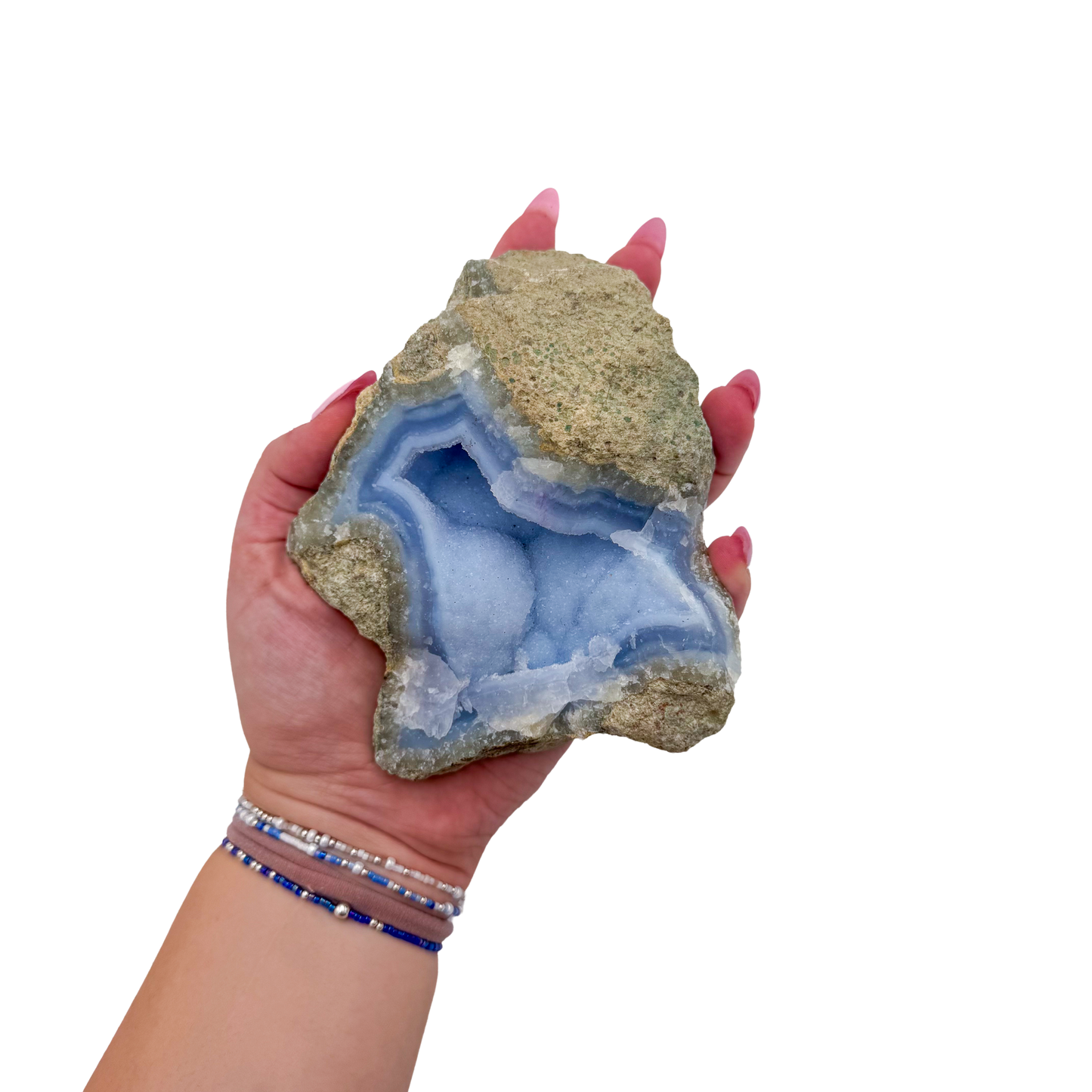 Blue lace agate raw geode held in hand to show scale