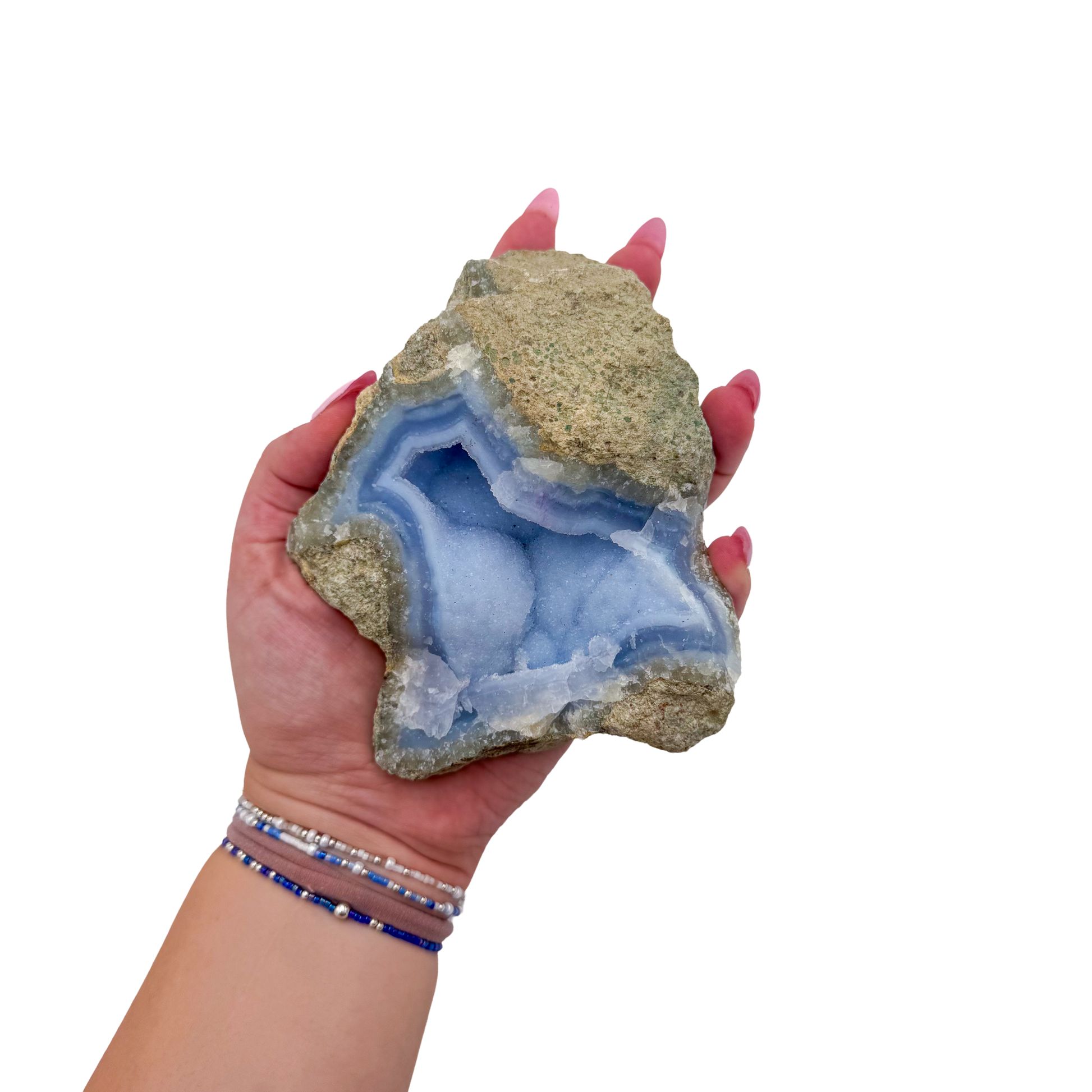 Blue lace agate raw geode held in hand to show scale