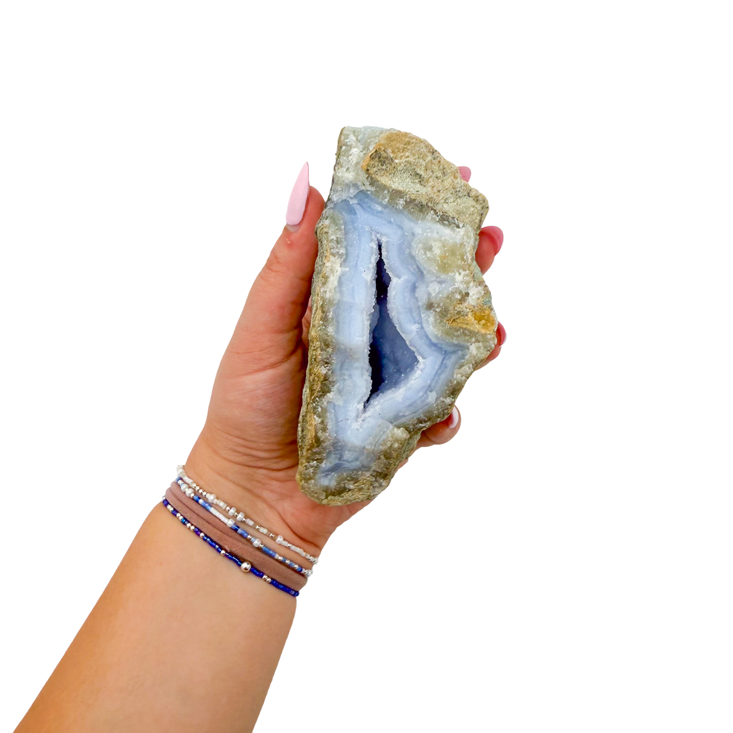 Blue lace agate raw geode held in hand to show scale