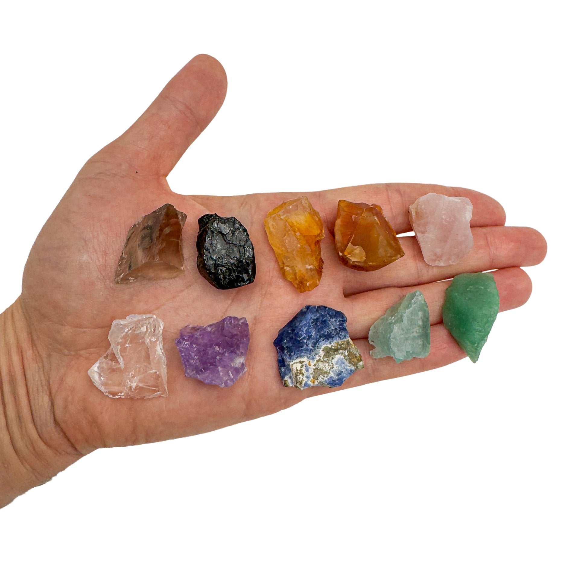 Ten small rough Brazilian crystals held in an open hand for scale