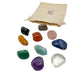 Brazilian tumbled stone set with its reusable cotton bag, all ten large crystals laid out on white