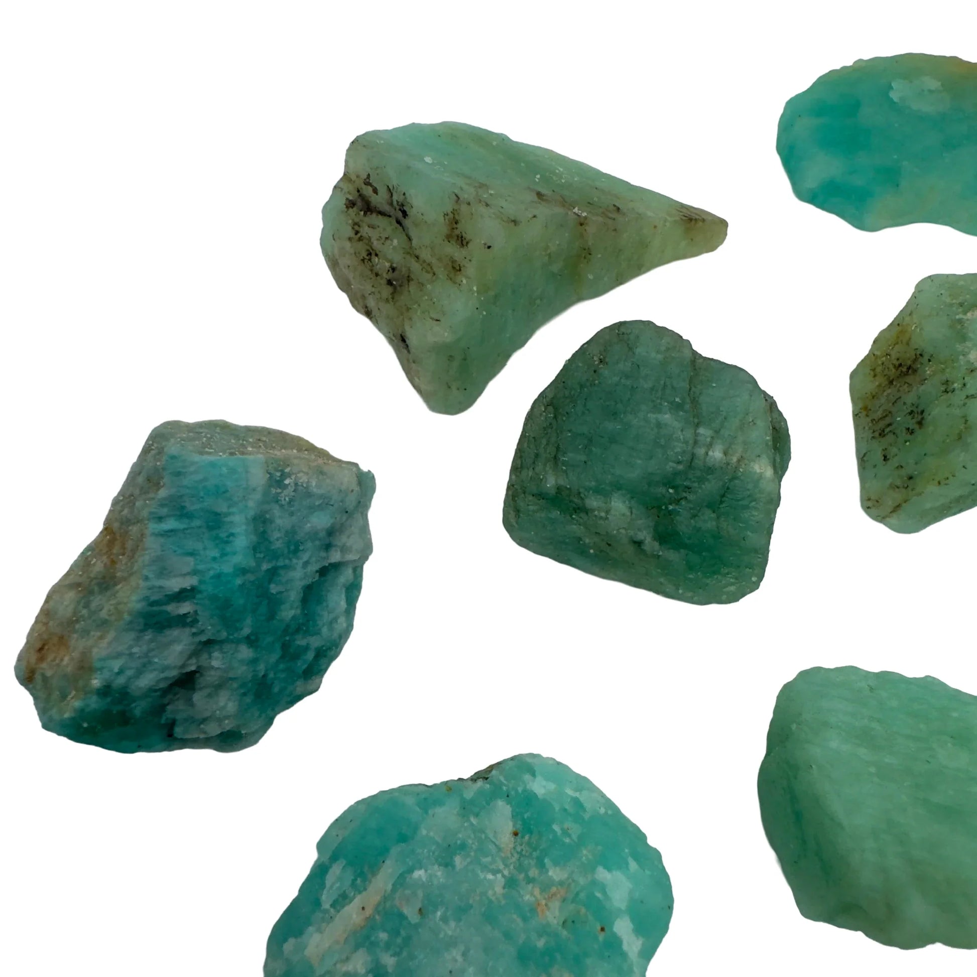 Hand-scale shot of a Amazonite raw stone held against natural backdrop, from Mozambique.