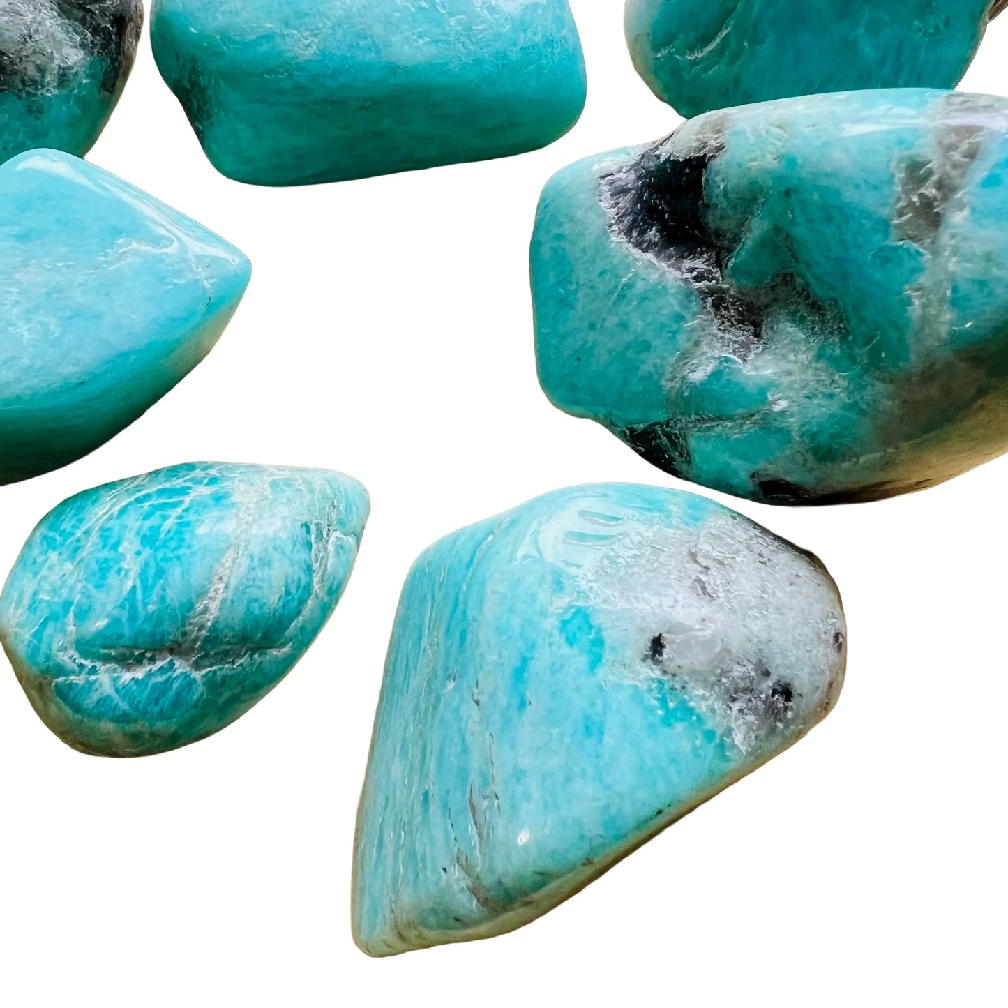 Natural light context of Amazonite tumbled stone, from Amboasitra, Madagascar, associated with Confidence, shown for shape and scale.