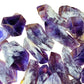 Palm-scale view of a single Amethyst raw point sourced from Bahia, Brazil.