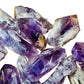 Grade aaa amethyst point held in hand for size reference