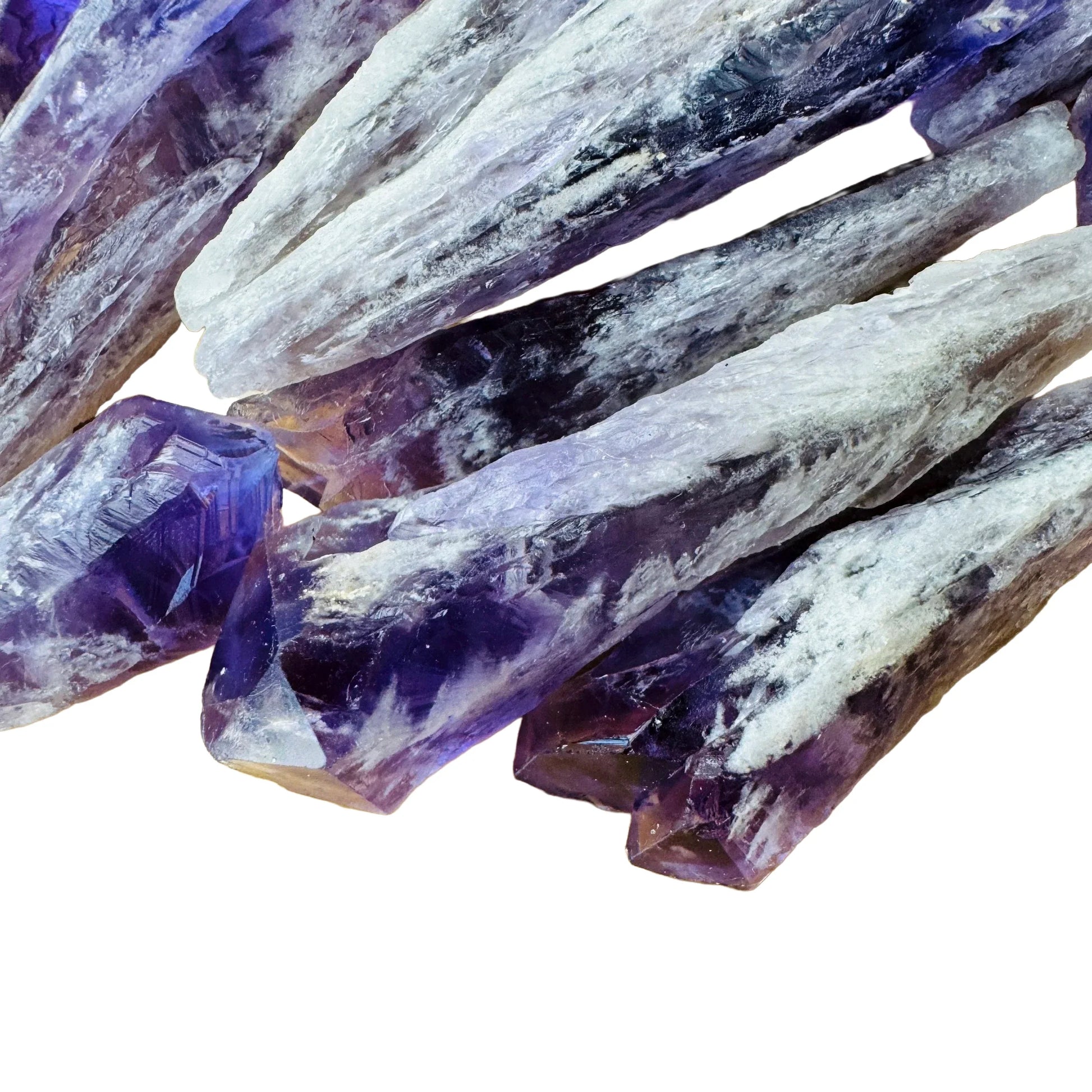 Hand-scale shot of a Amethyst raw point held against natural backdrop, sourced from Bahia, Brazil.