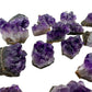 Grade aa amethyst cluster held in hand for size reference