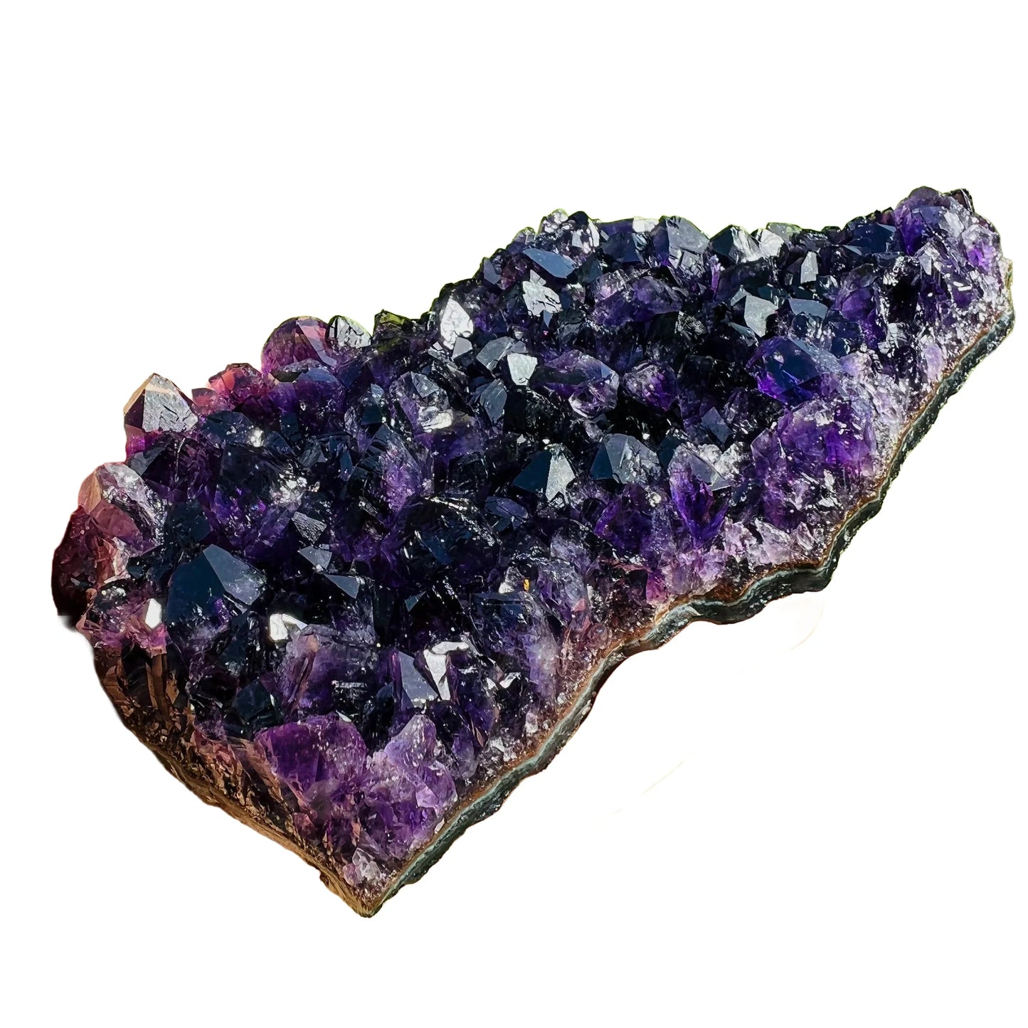 Size comparison with a Amethyst specimen held against natural backdrop, from Uruguay.
