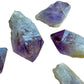 Palm-scale view of a single Amethyst raw point hand-selected from Southern Province, Zambia.