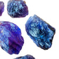 Lifestyle view of a Amethyst raw stone held against natural backdrop, hand-selected from Rio Grande do Sul, Brazil.