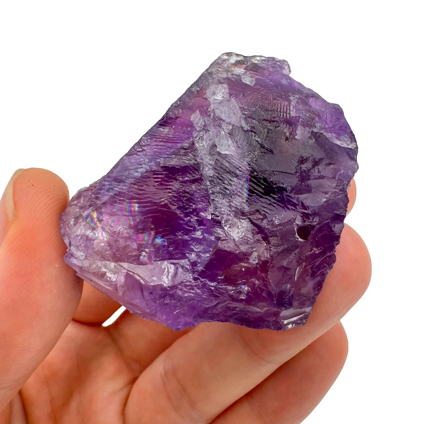 Grade aa amethyst raw held in hand for size reference