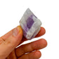 Grade a amethyst raw held in hand for size reference