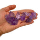 Hand holding small amethyst raw crystals 5-10 grams Brazil scale reference