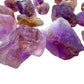 In-hand view of a single Ametrine raw stone from Ángel Sandoval Province, Bolivia.