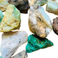 Grade a blue opal raw held in hand for size reference