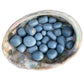 Detail shot of Grade A Angelite tumbled stone under natural light