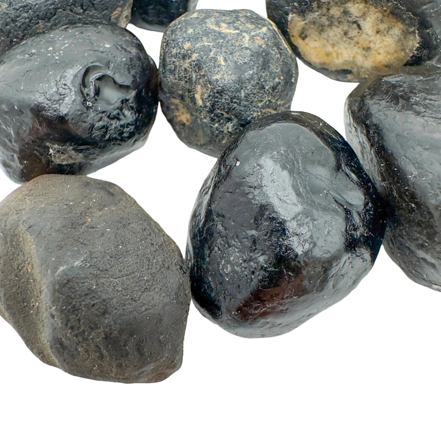 Top-side view of Apache Tear raw stone, showing natural color depth, hand-selected from Arizona, United States.