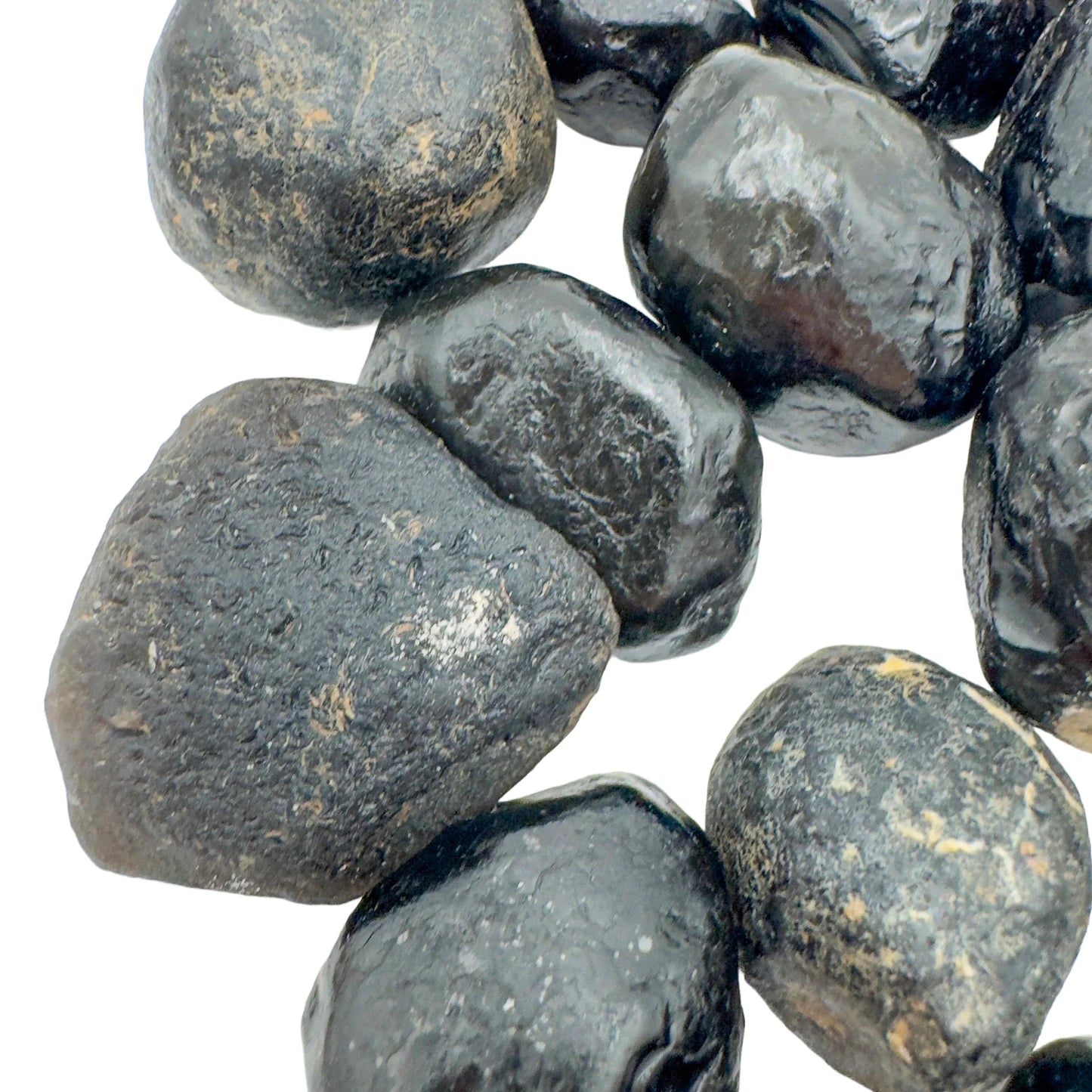 Underside view of Grade A Apache Tear raw stone, linked to Grounding, from Arizona, United States.