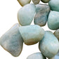 Detail of Aquamarine tumbled stone, showing natural sheen, linked to Stress Relief.