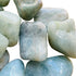 Edge view of Aquamarine tumbled stone, traditionally used for Stress Relief, showing characteristic color.