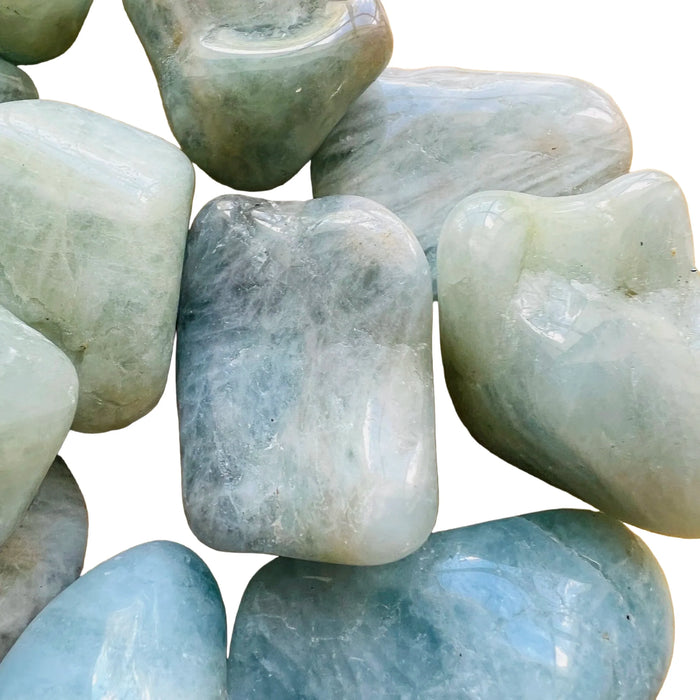 Edge view of Aquamarine tumbled stone, traditionally used for Stress Relief, showing characteristic color.