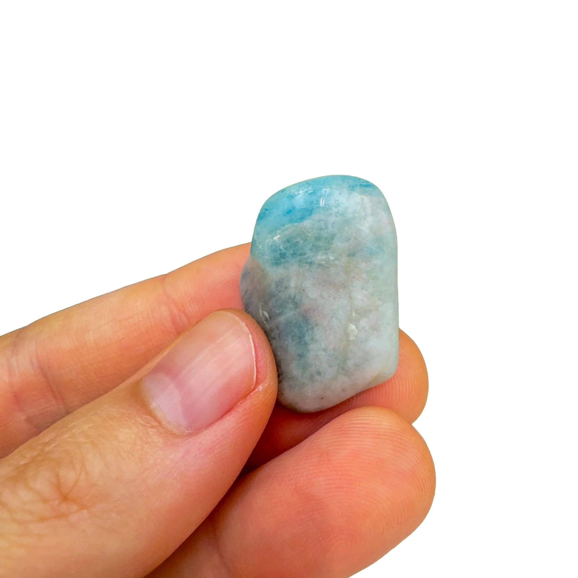 Hand-scale shot of a Aquamarine tumbled stone often kept for Stress Relief.