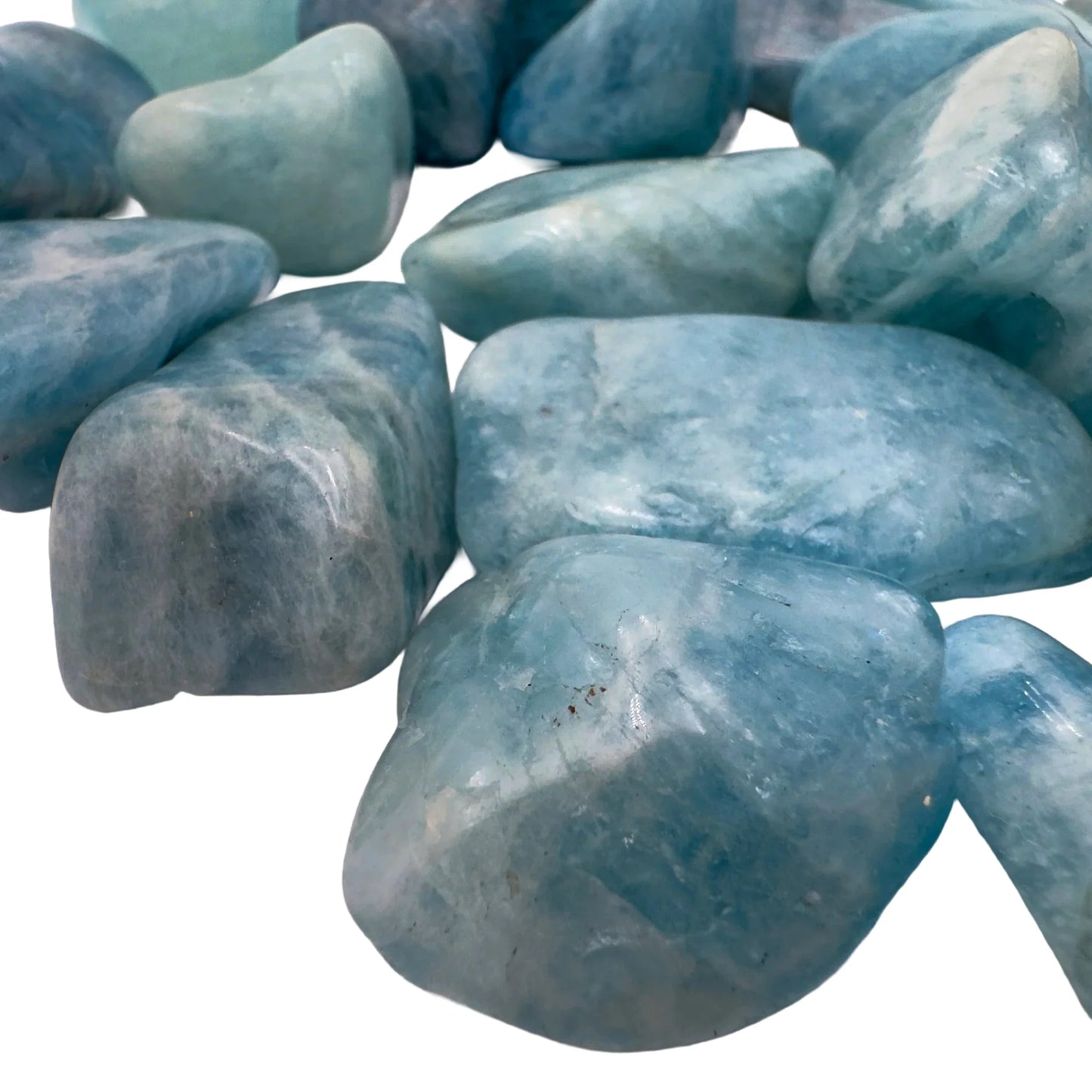 Overhead view of Aquamarine tumbled stone, often worked with for Stress Relief, Brazil-sourced.