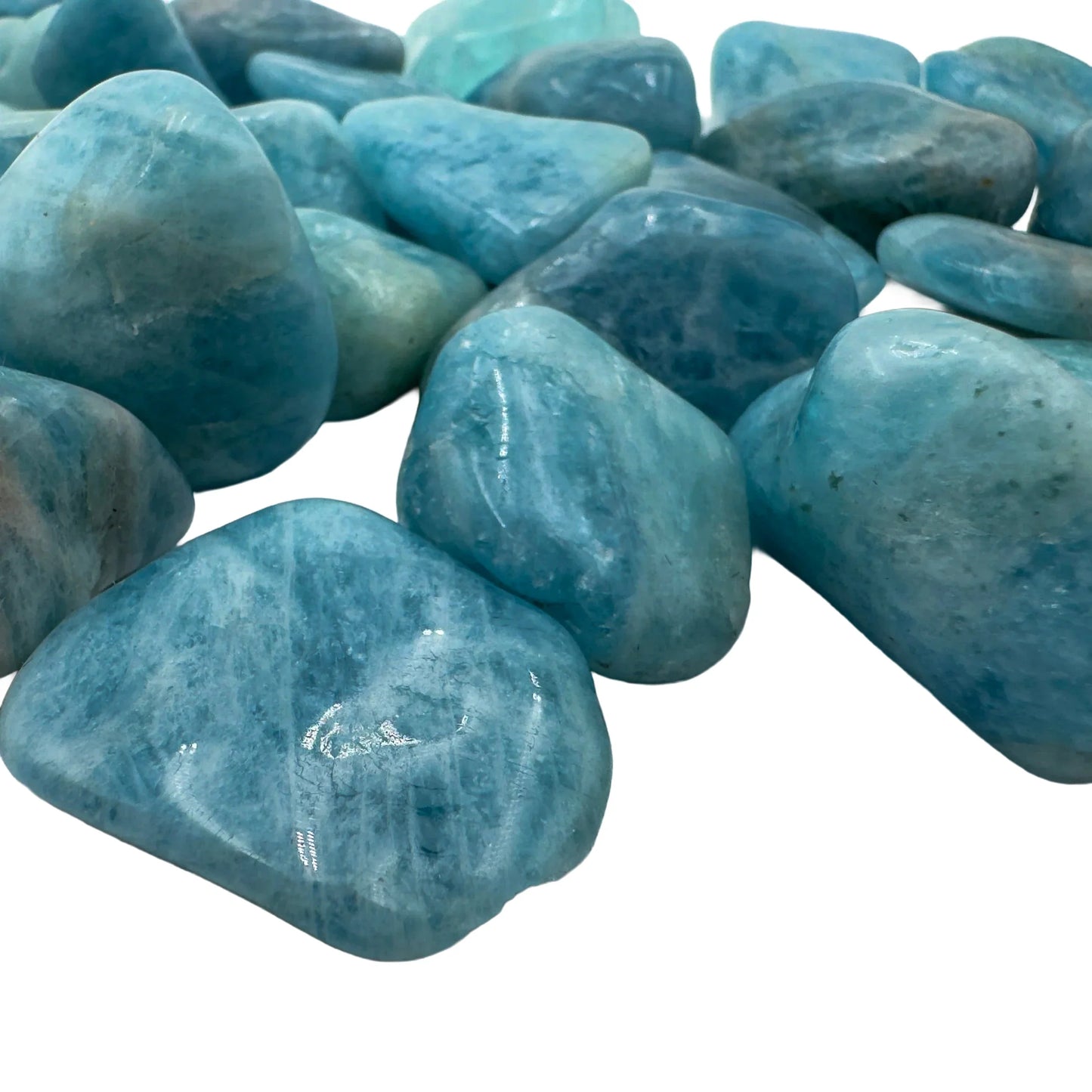 Scale reference of a Aquamarine tumbled stone often paired with practices around Stress Relief.