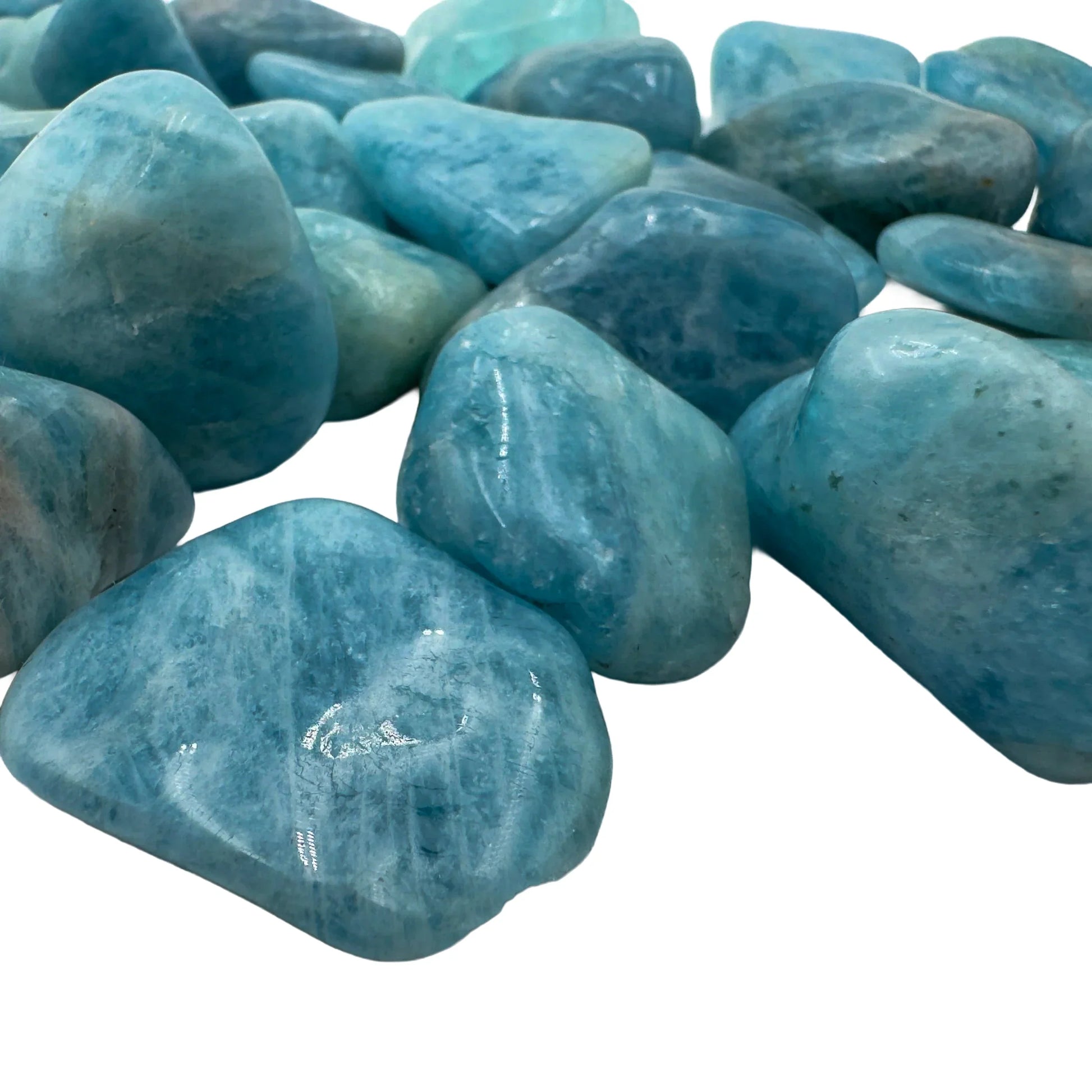Scale reference of a Aquamarine tumbled stone often paired with practices around Stress Relief.