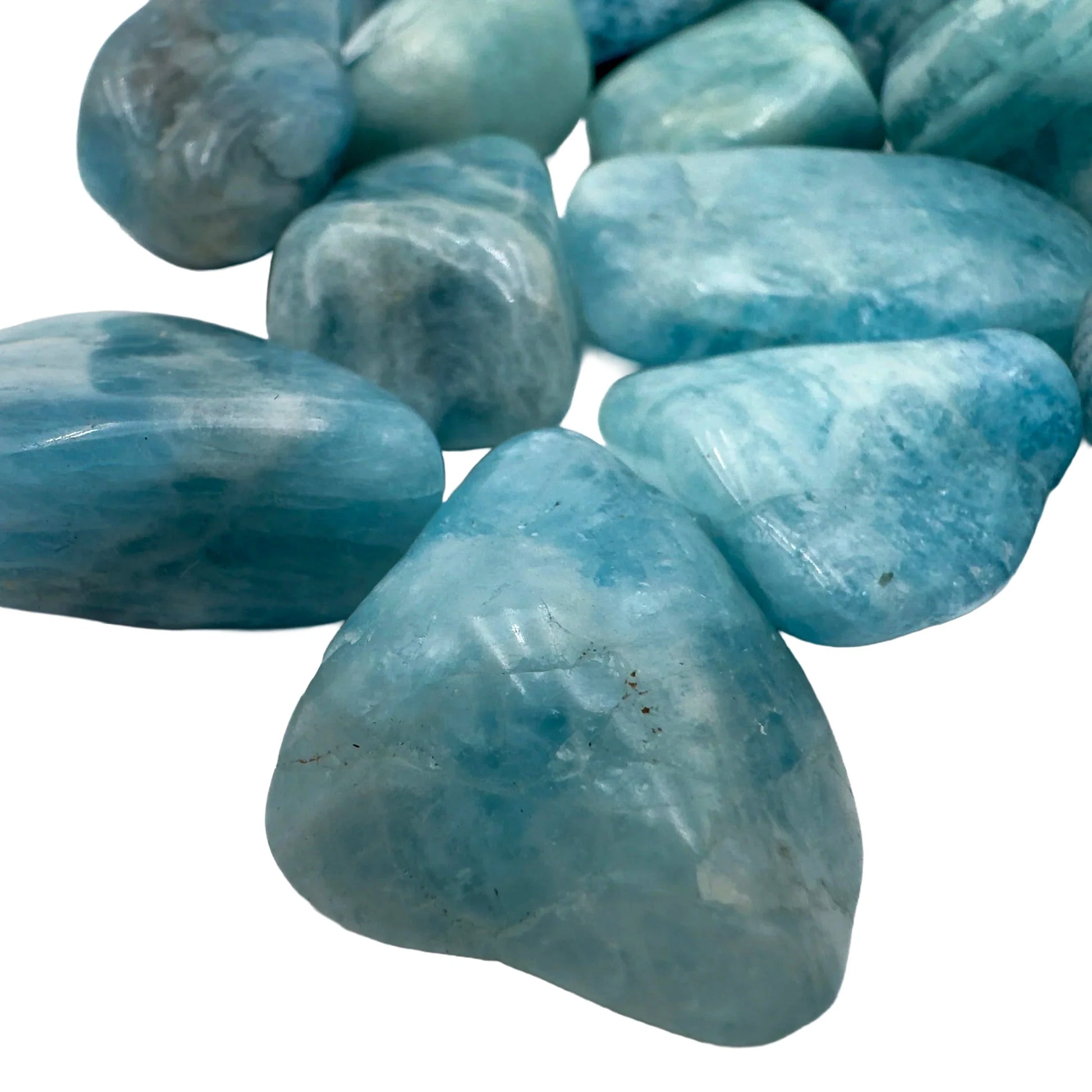 Styled with natural light Aquamarine tumbled stone, with depth visible across the surface.