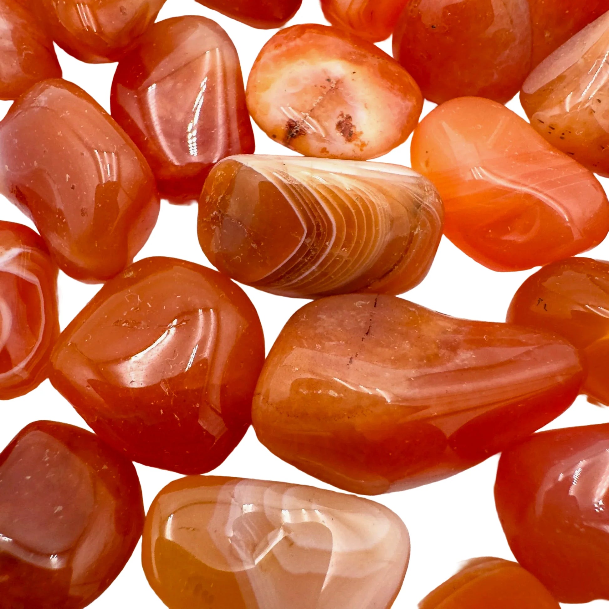 Side angle of Carnelian tumbled stone, showing translucent edges.