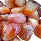 Plan view of Carnelian tumbled stone, showing earthy tone, Botswana-sourced.