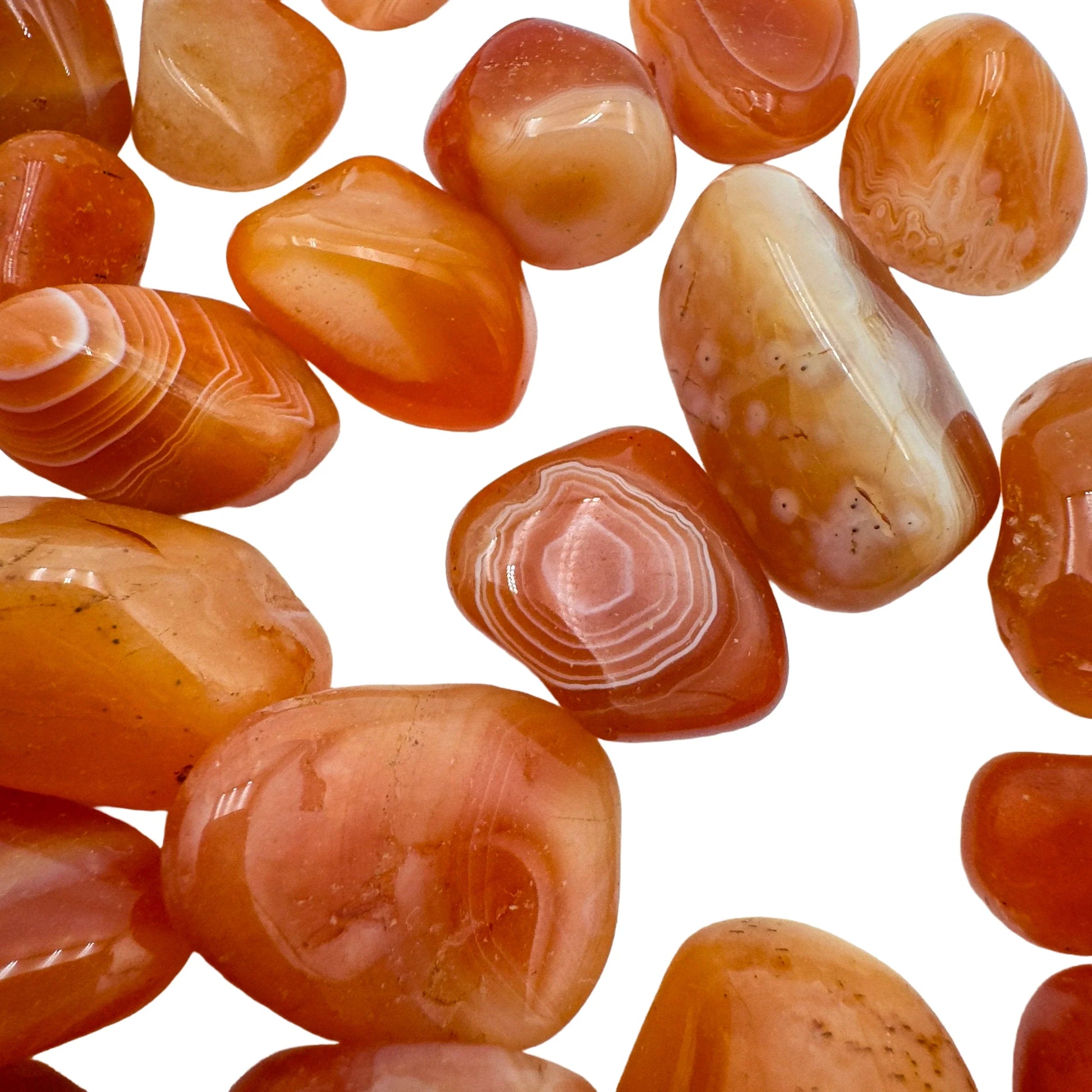 Worktop view of Carnelian tumbled stone, linked to Creativity, with depth visible across the surface.