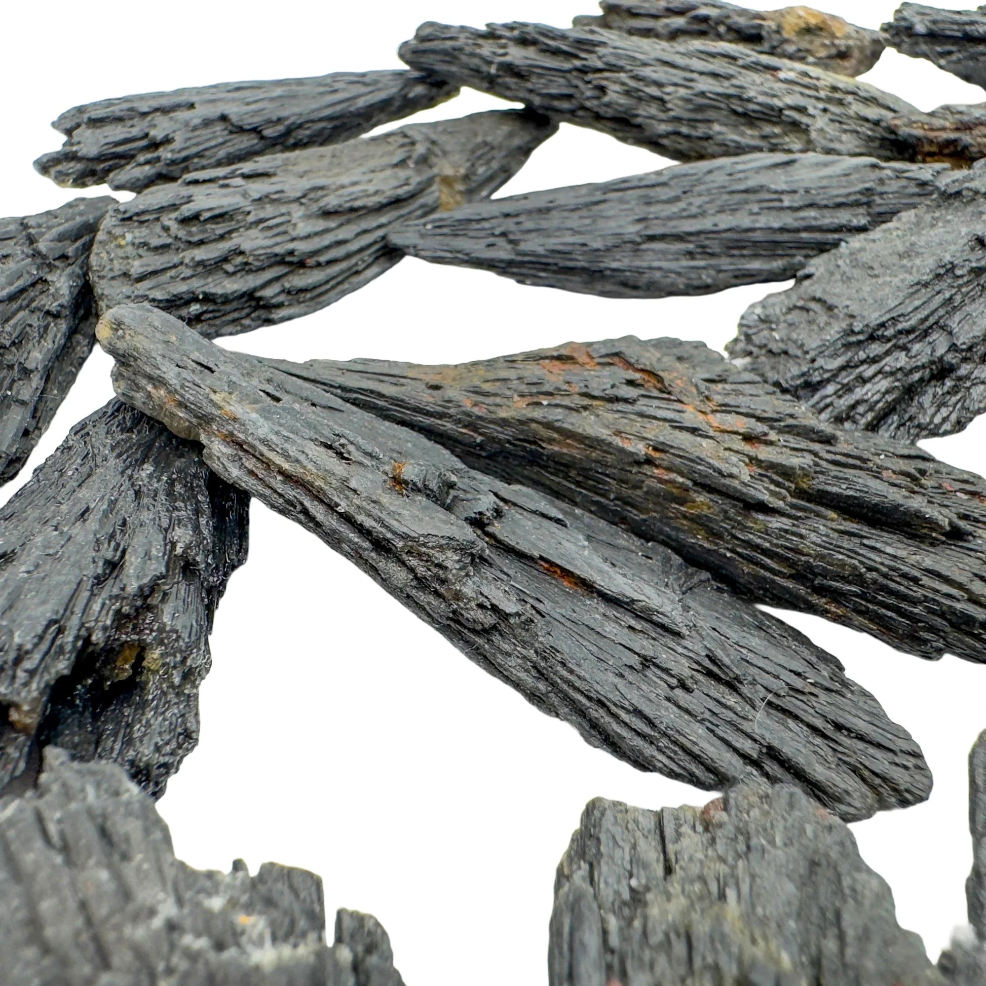 In-hand view of one Black Kyanite raw stone for scale, sourced from Brazil.