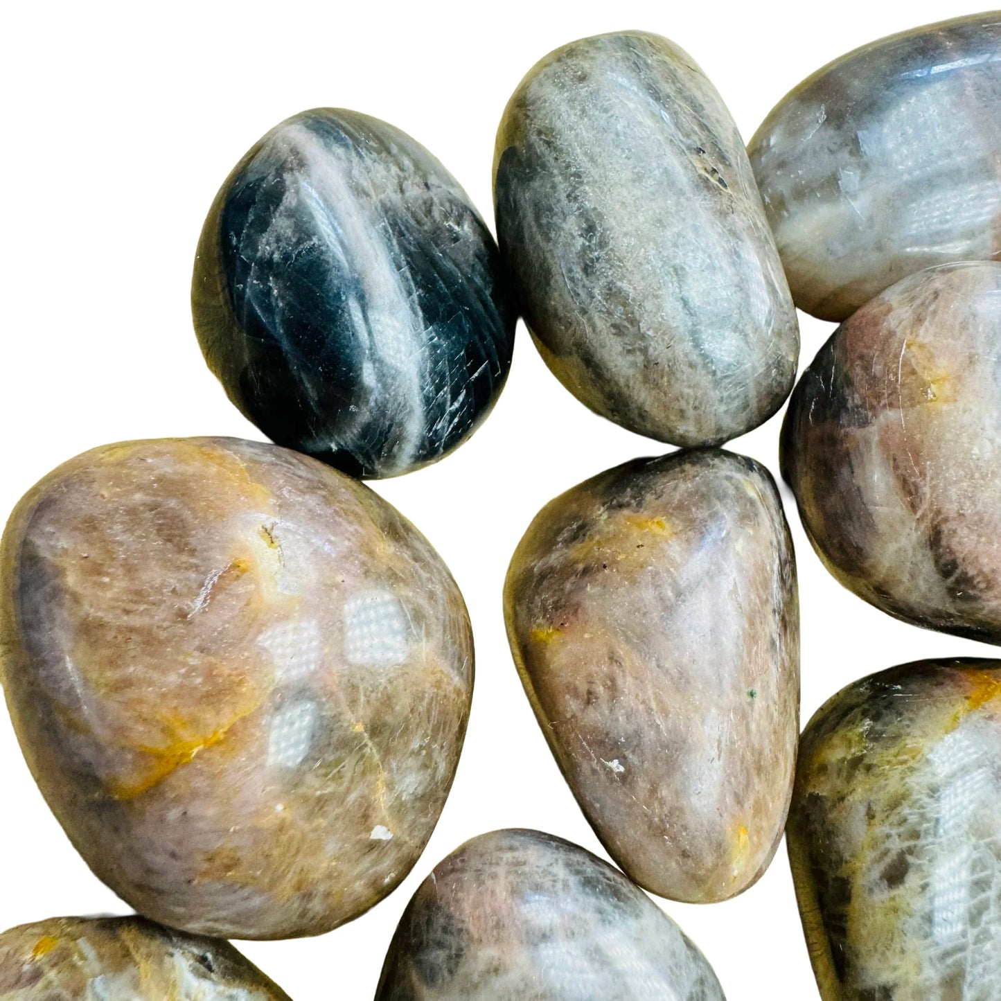 Sideways view of Black Moonstone tumbled stone, showing color depth.
