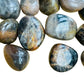 Palm-scale view of a Black Moonstone tumbled stone, Madagascar-sourced, Madagascar-sourced.