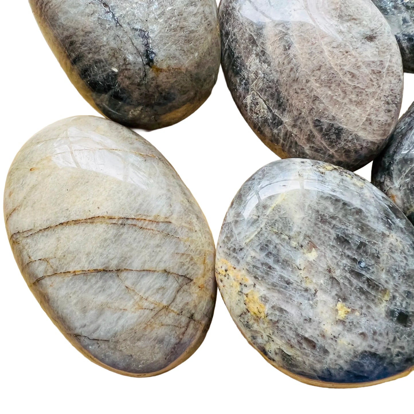 Near view of Black Moonstone palm stone, showing earthy tone, turned to for Grounding.