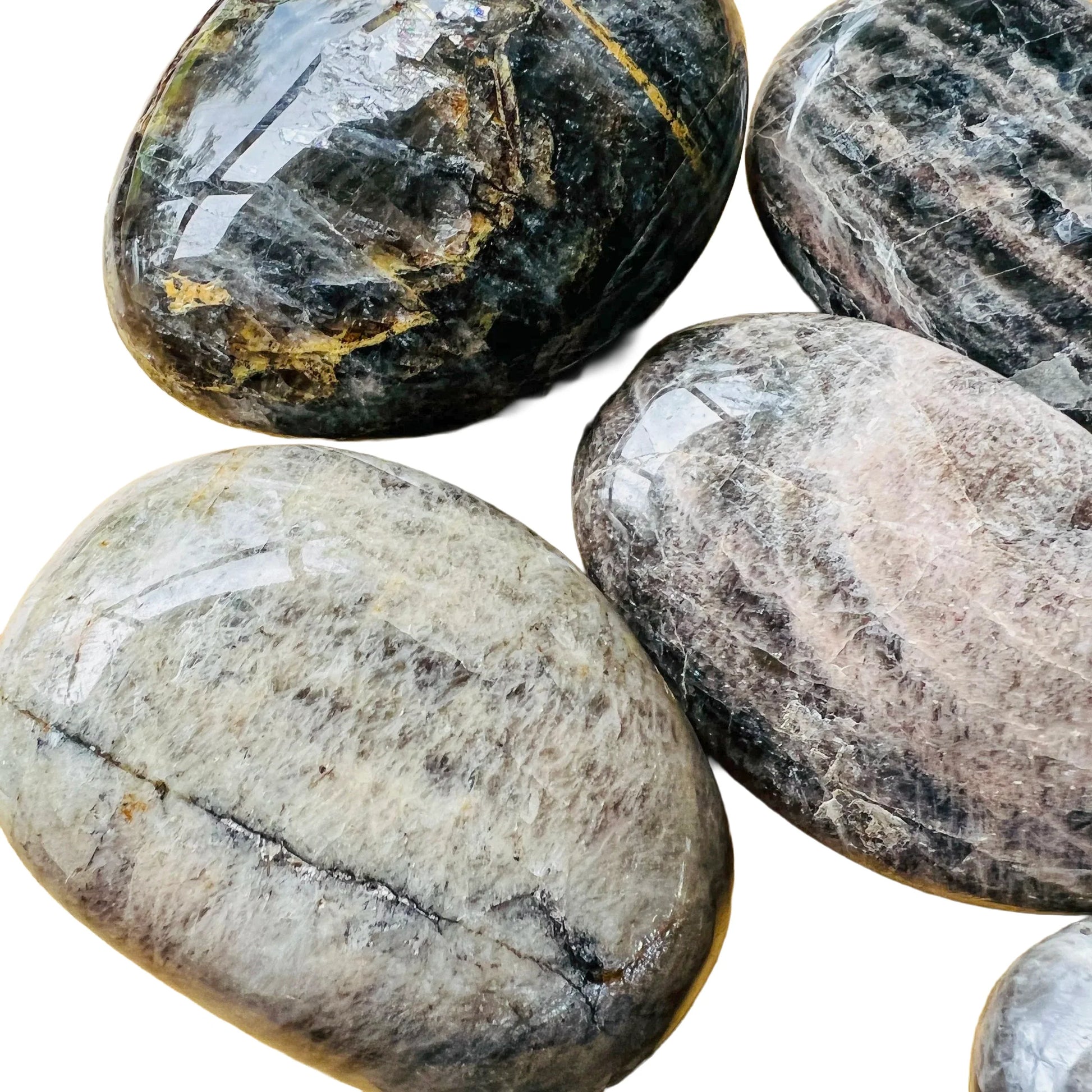 Side-on view of Black Moonstone palm stone, Madagascar-sourced, showing natural inclusions.