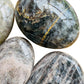 Opposite side of Black Moonstone palm stone, from Amoron'i Mania, Madagascar, traditionally used for Grounding and Protection.
