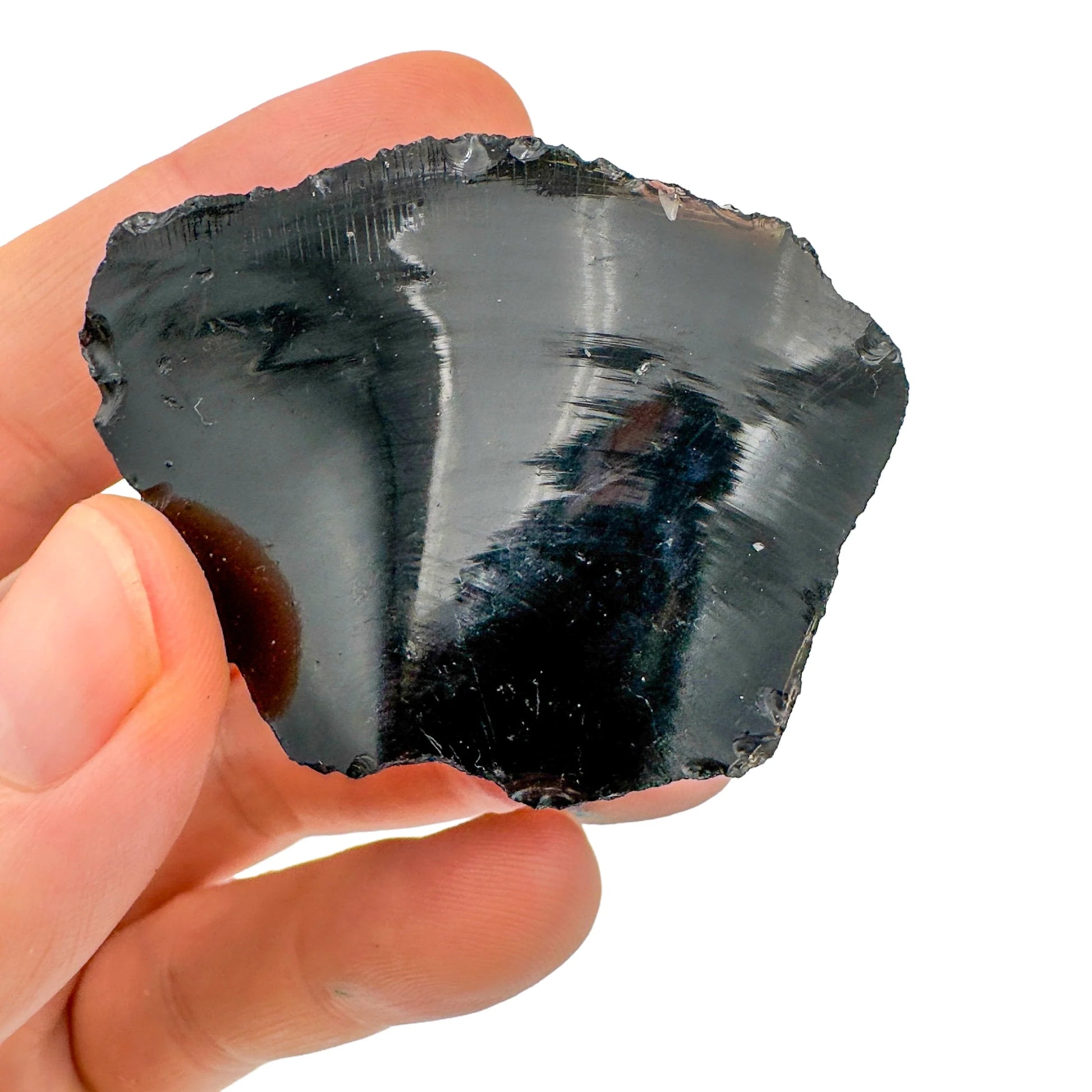 Grade aa black obsidian raw held in hand for size reference