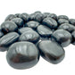 Detail capture of Grade AA Black Onyx tumbled stone, showing natural variation.