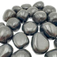 Lateral view of Black Onyx tumbled stone, Peru-sourced, showing subtle veining.