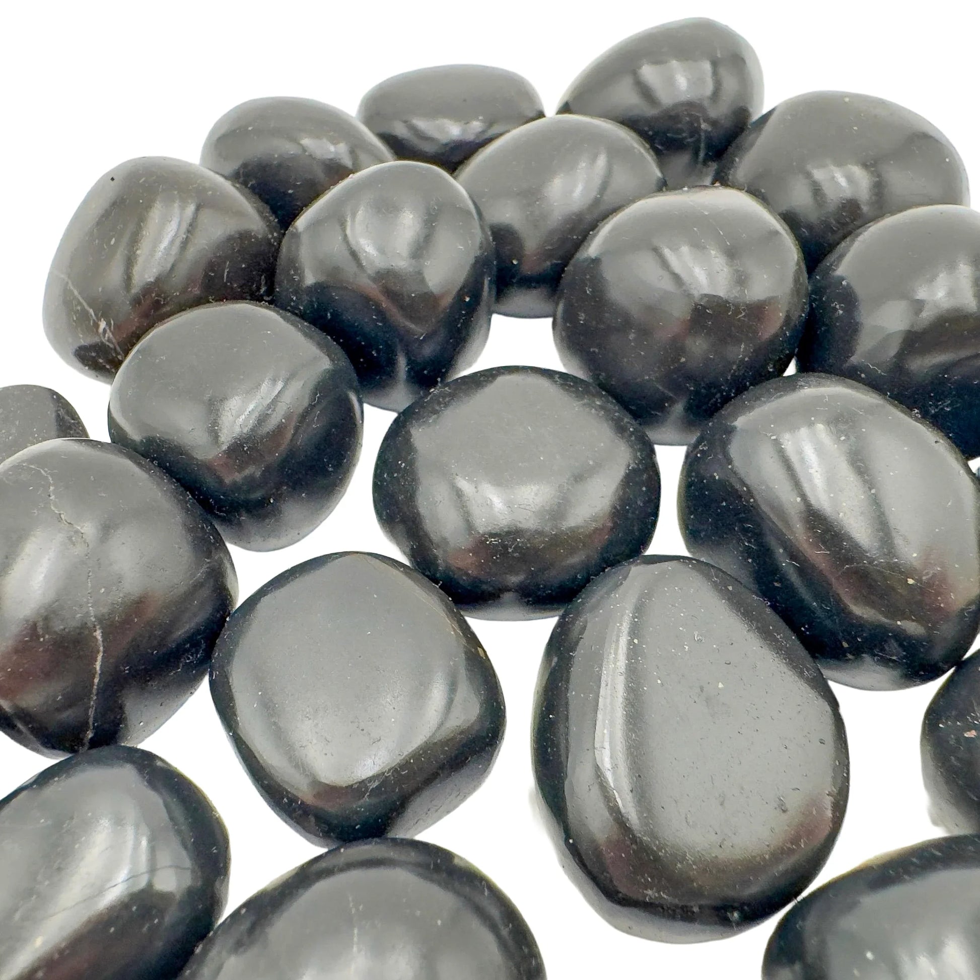Lateral view of Black Onyx tumbled stone, Peru-sourced, showing subtle veining.