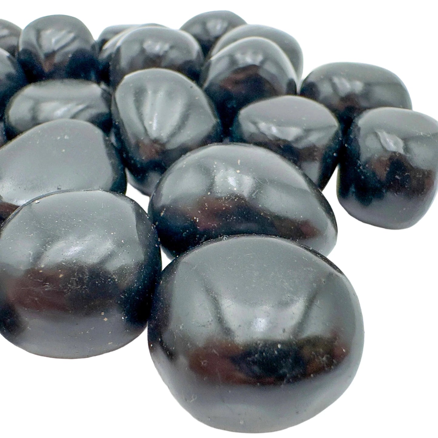 Overhead view of Grade AA Black Onyx tumbled stone, worked with for Protection and Grounding, from Ancash, Peru.