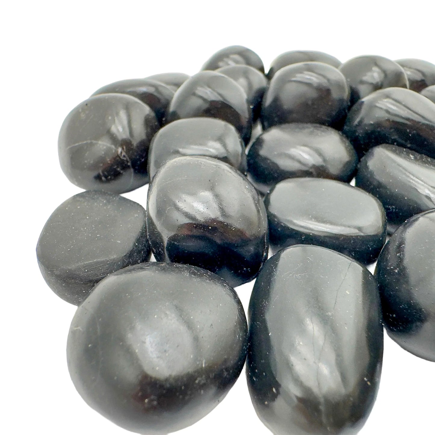 Palm-scale view of one Black Onyx tumbled stone for scale, Peru-sourced, hand-selected from Ancash, Peru.