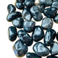 Side angle of Black Onyx tumbled stone, sourced from Brazil, often kept for Protection.