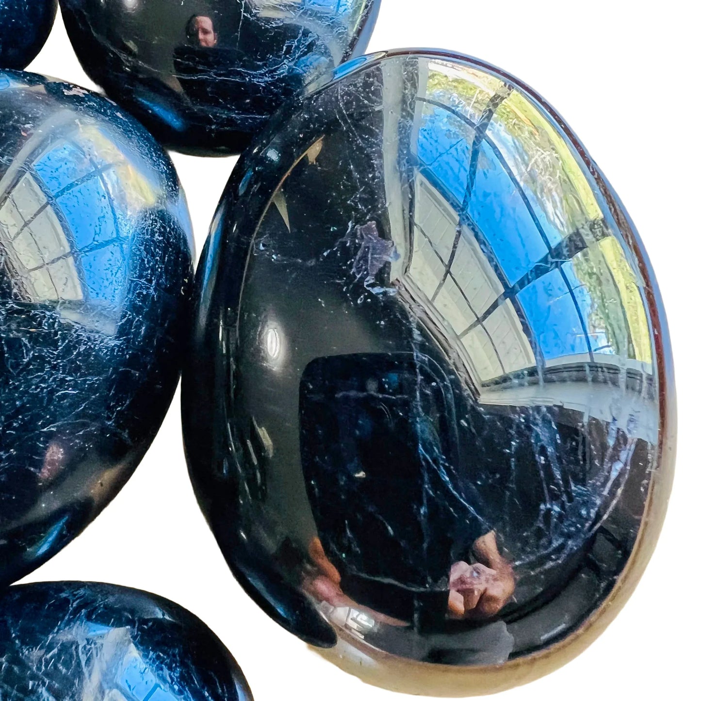 Top view of Black Tourmaline palm stone, showing soft luster, from Alaotra-Mangoro, Madagascar.